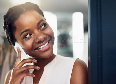 Buy stock photo Cropped shot of a young business owner talking on a cellphone in her shop