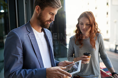 Buy stock photo Creative, professional and man with tablet in workplace for collaboration, design and woman with coffee. Coaching, development and teamwork in workplace for digital agency, planning and brainstorming