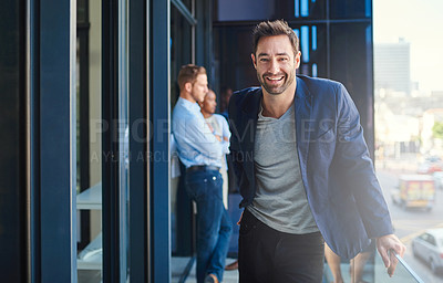 Buy stock photo Cropped shot of a businessman standing on a balcony with his coworkers in the background