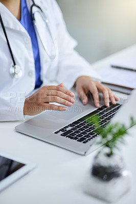 Buy stock photo Closeup shot of a doctor working on a laptop in an office