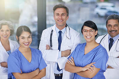 Buy stock photo Portrait of a team of medical practitioners standing together in a hospital