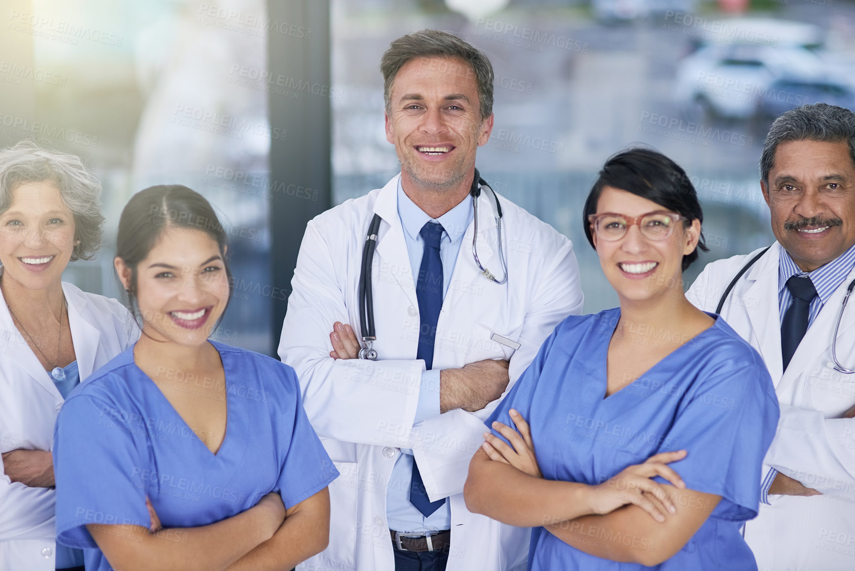 Buy stock photo Portrait of a team of medical practitioners standing together in a hospital