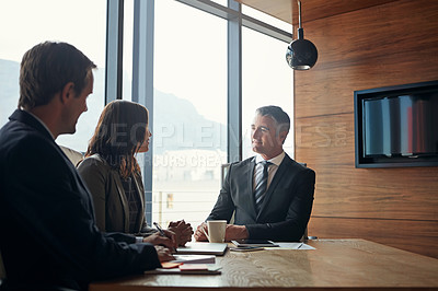 Buy stock photo Shot of a team of professionals having a meeting in a boardroom