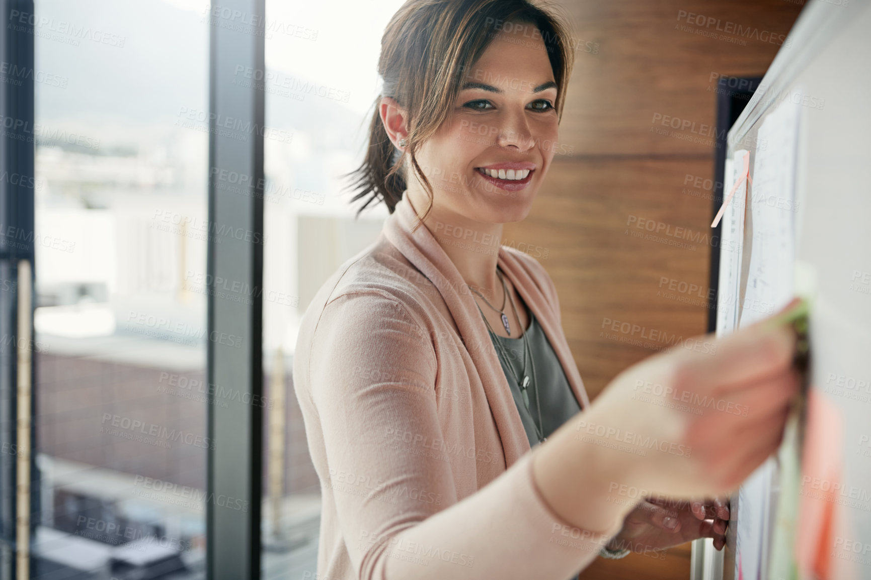 Buy stock photo Cropped shot of a young businesswoman outlining an idea with adhesive notes