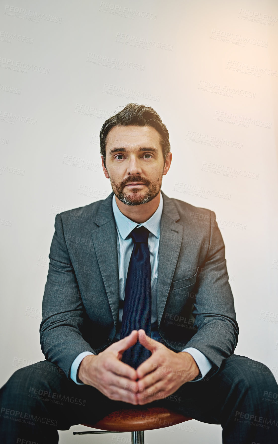 Buy stock photo Business, portrait and mature man on office chair with triangle hands, mindset or power pose on wall background. Face, goals or male lawyer at law firm with ambition, career or fierce attitude