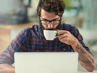 Buy stock photo Man, laptop and coffee in office for agency with online connection, reading email and web design software. Male designer, beverage and technology in creative workspace with tattoo, wordpress and wifi
