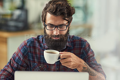 Buy stock photo Man, laptop and coffee in workplace for agency with online connection, reading email and web design software. Male designer, beverage and technology in modern office with tattoo, wordpress and wifi