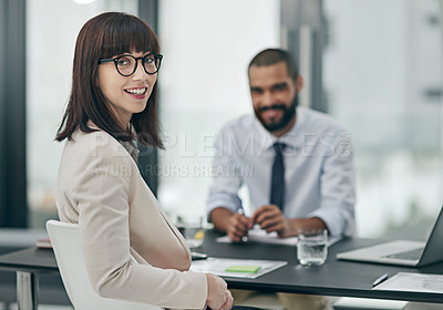 Buy stock photo Cropped portrait of a young businesswoman working with a male colleague in the office