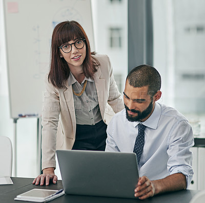 Buy stock photo Cropped portrait of a young businesswoman helping a male colleague in the office