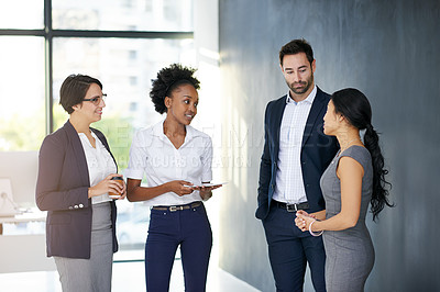 Buy stock photo Cropped shot of a group of businesspeople talking in the office