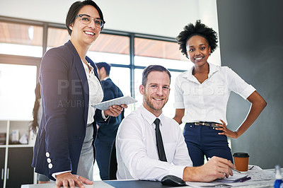 Buy stock photo Cropped portrait of a group of businesspeople gathered around a computer in their office