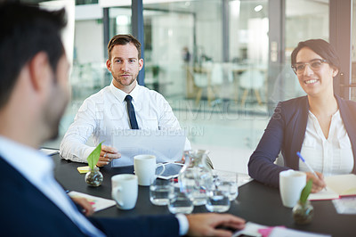Buy stock photo Cropped shot of a group of colleagues meeting in the boardroom