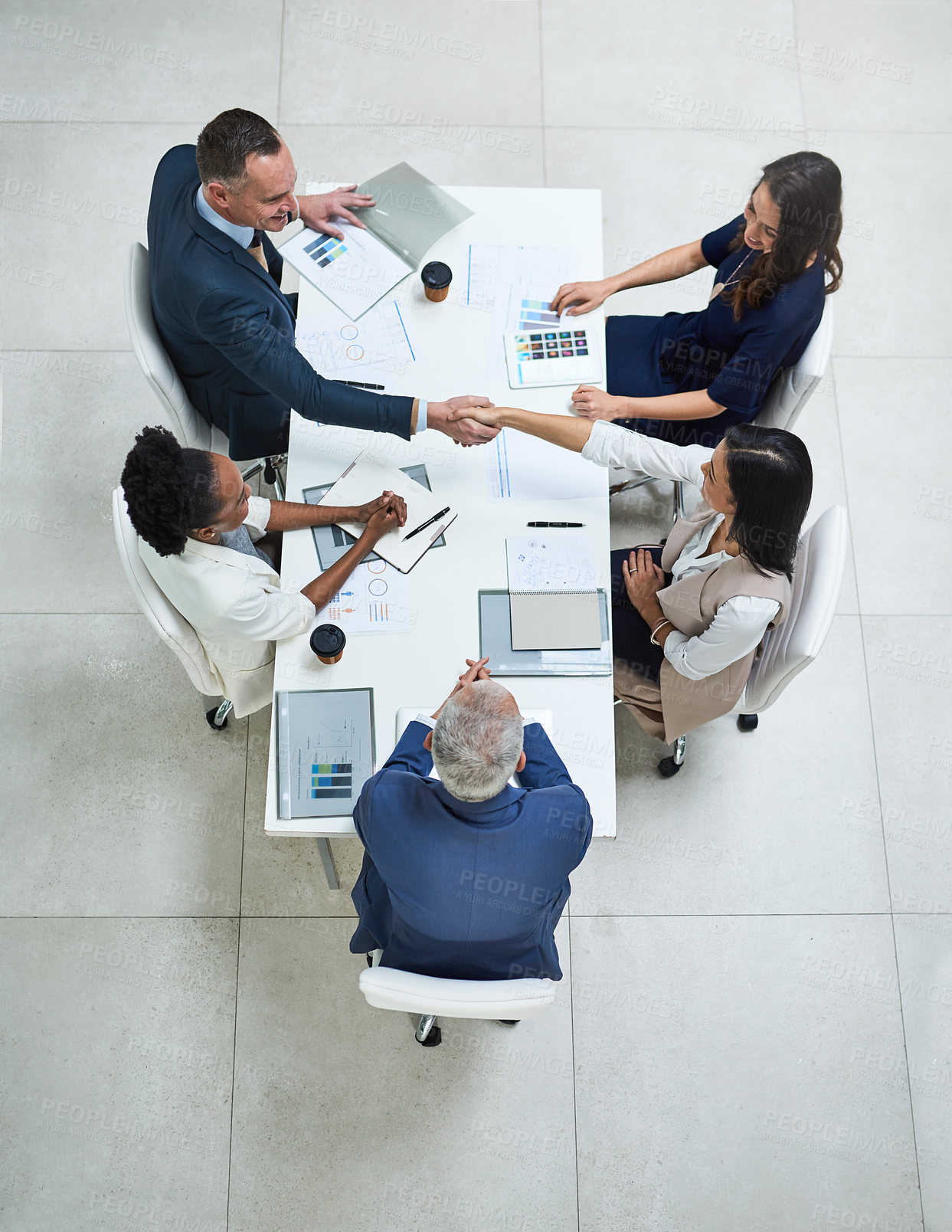 Buy stock photo High angle shot of businesspeople having a meeting in a modern office