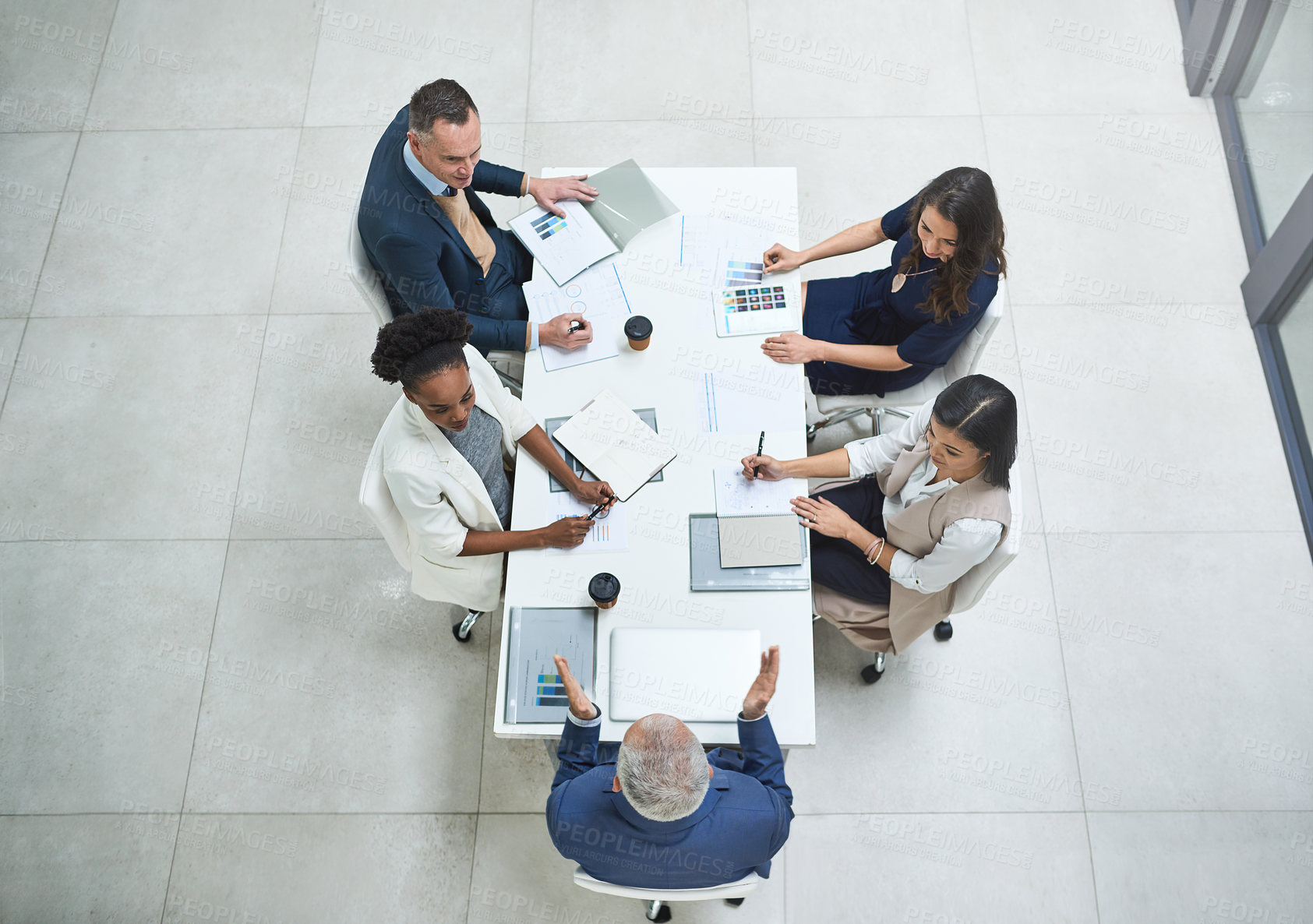 Buy stock photo High angle shot of businesspeople having a meeting in a modern office