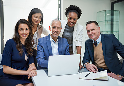 Buy stock photo Portrait of a group of businesspeople working together on a laptop in a modern office