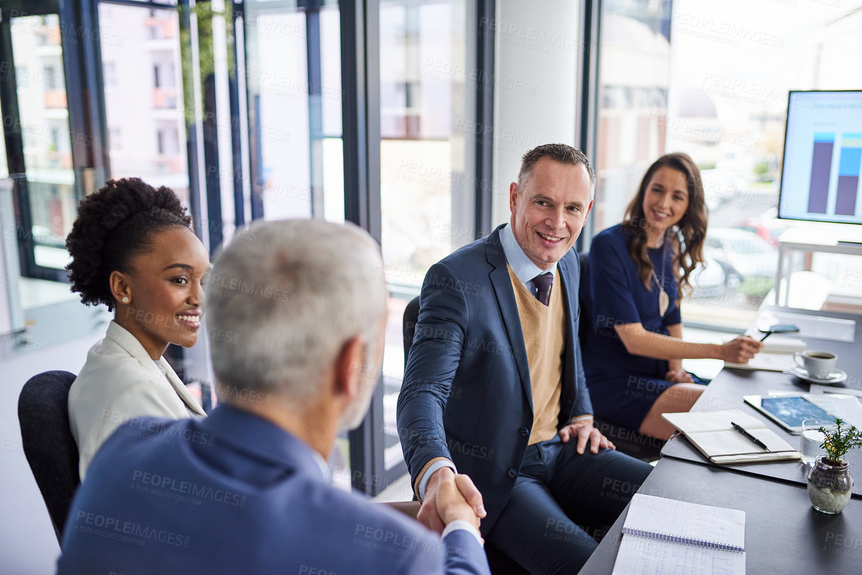 Buy stock photo Cropped shot of businesspeople shaking hands during a boardroom meeting