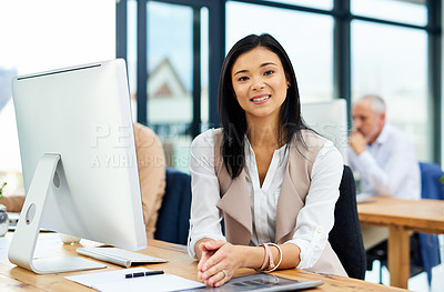 Buy stock photo Cropped portrait of a young businesswoman working in her office with colleagues in the background