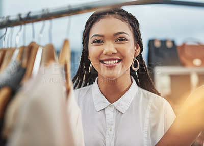 Buy stock photo Cropped portrait of a woman looking at clothes on a rail in a store