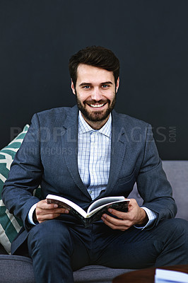 Buy stock photo Smile, book and portrait of businessman reading on sofa in waiting area for corporate knowledge at office. Happy, career and male financial advisor enjoying finance literature on couch in workplace.