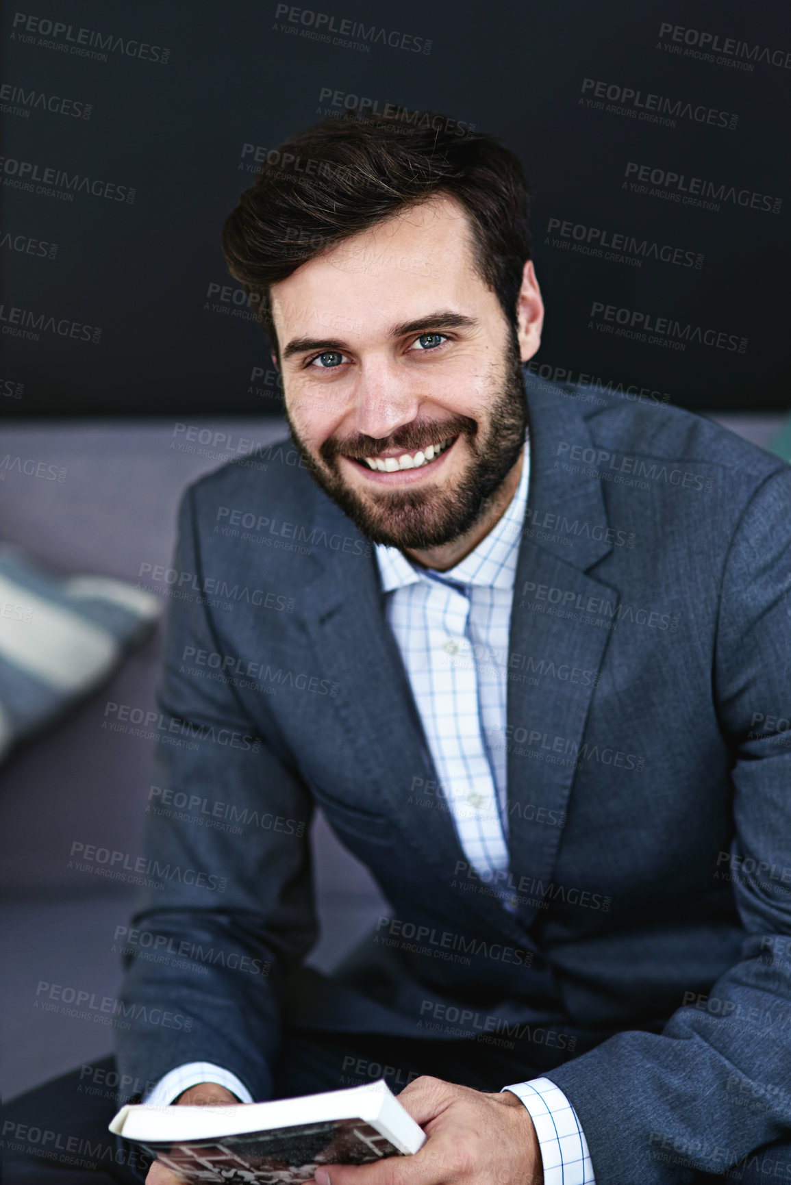 Buy stock photo Happy, book and portrait of businessman reading on sofa in waiting area for corporate knowledge at office. Smile, career and male financial advisor enjoying finance literature on couch in workplace.