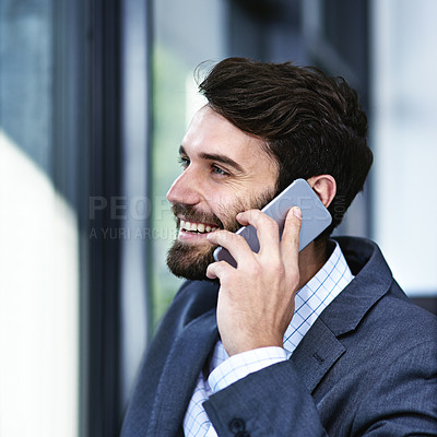 Buy stock photo Happy, businessman and phone call with discussion for chat, proposal or communication by window at office. Young man or employee talking on mobile smartphone with smile for business conversation
