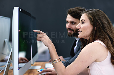 Buy stock photo Cropped shot of businesspeople working together on a computer in a modern office