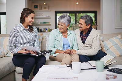 Buy stock photo Shot of a young insurance rep presenting a product to elderly clients in their home