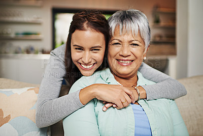 Buy stock photo Cropped portrat of a young woman hugging her mature mother in the living room