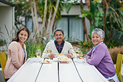 Buy stock photo Cropped portrait of a family enjoying lunch together outside