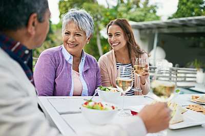 Buy stock photo Mature mother, female daughter and smile with lunch on  table and conversation with father for eating and enjoyment. Family, happy and food with wine or meal and bonding together on holiday in nature