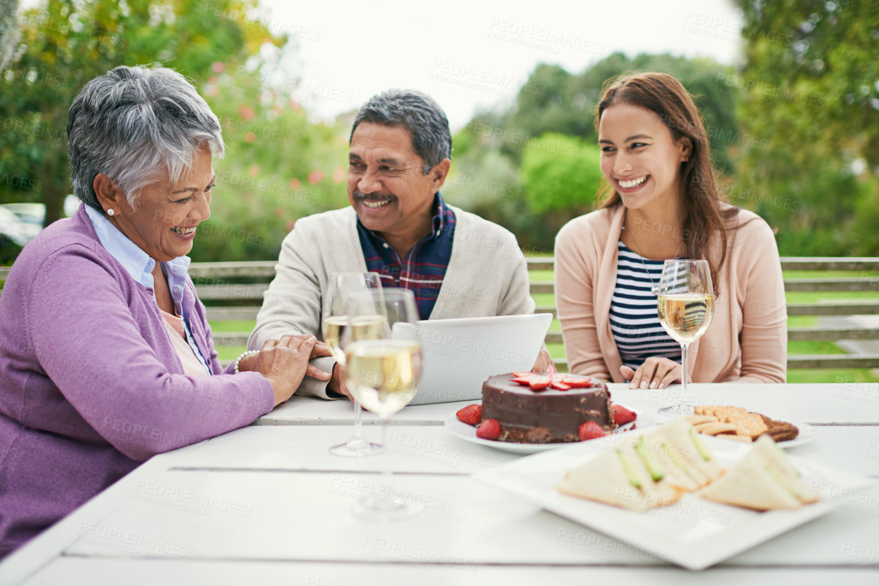 Buy stock photo Senior, couple and romance, outdoor and tablet for celebration of anniversary of parents with champagne. Summer, relax and weekend, cake and lunch for brunch in backyard or garden, woman and family