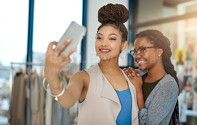 Buy stock photo Shot of two young fashion designers taking a selfie at work
