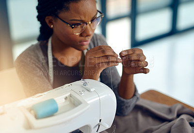 Buy stock photo Shot of a young designer doing some needle work
