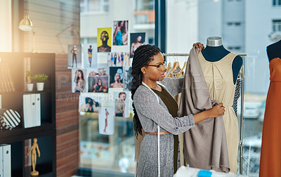 Buy stock photo Shot of a young woman working in her clothing boutique