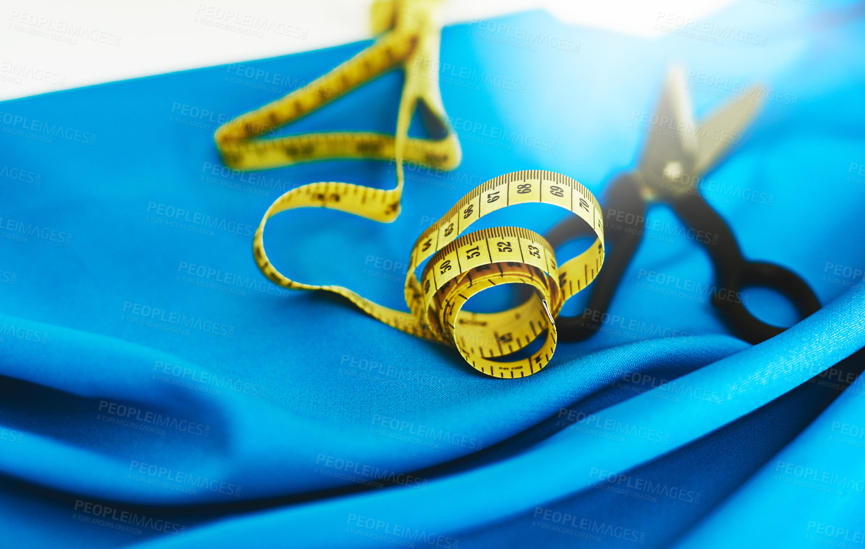 Buy stock photo Fashion design, scissors and fabric with tape measure in studio for clothes, garment and process. Tools, equipment and material for textile, cloth and empty workshop with creativity for production