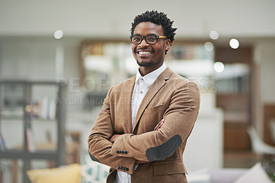 Buy stock photo Cropped portrait of a confident young businessman standing with his arms folded in his office