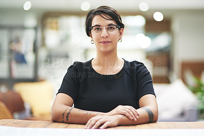 Buy stock photo Cropped portrait of a young businesswoman sitting at her desk in her office