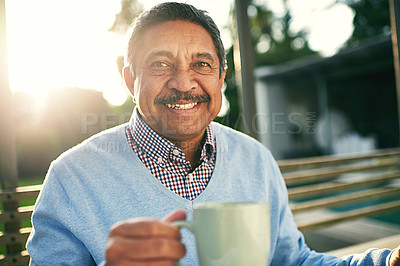 Buy stock photo Portrait of an older man enjoying his morning coffee outdoors