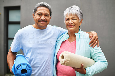 Buy stock photo Portrait of a happy older couple carrying their exercise mats outdoors