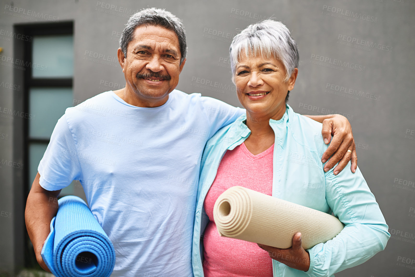 Buy stock photo Portrait of a happy older couple carrying their exercise mats outdoors