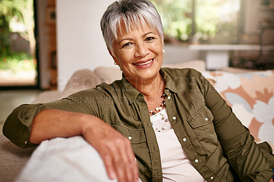 Buy stock photo Portrait of a happy older woman relaxing on the sofa at home