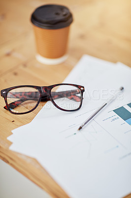 Buy stock photo Glasses, coffee cup and documents with charts, graph and financial report for accountant on desk in office. Spectacles, disposable drink and paperwork for business statistics and finance review