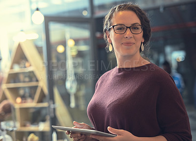 Buy stock photo Portrait of a young entrepreneur using a digital tablet in her store
