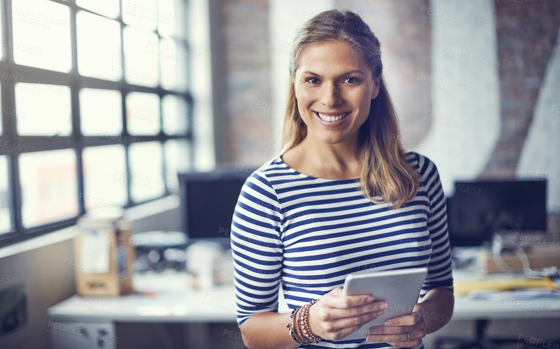 Buy stock photo Portrait of a young designer using her digital tablet in her office