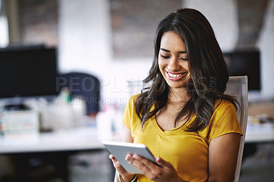 Buy stock photo Shot of a young designer working on a digital tablet in an office