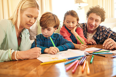 Buy stock photo Parents, kids and learning with color for drawing, picture or art in early childhood development at home. Mother, father and children writing on paper for sketching with crayons or colorful pencils