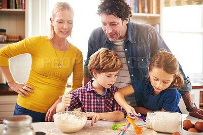 Buy stock photo Mother, father and children in kitchen baking cookies for learning, development and bonding as family. Mom, dad and kids mixing ingredients for desserts, pastries or biscuits and cake together 