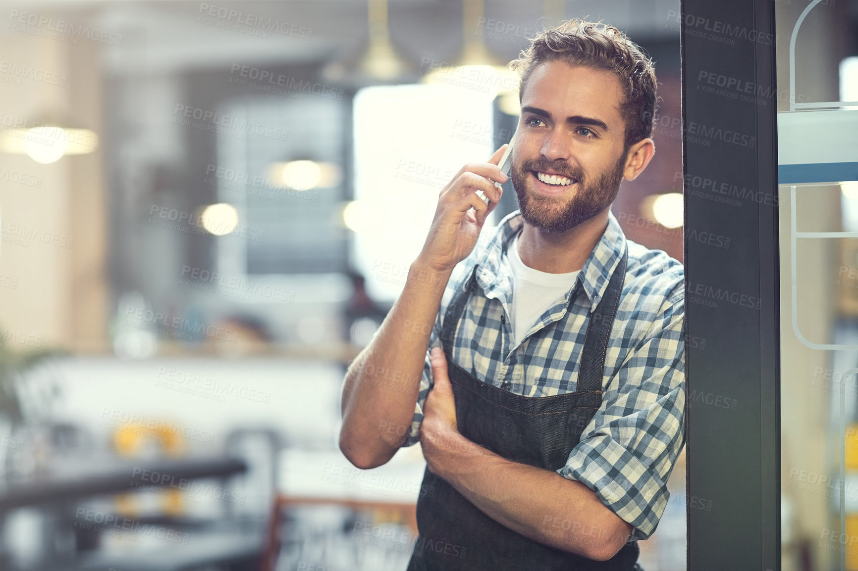 Buy stock photo Happy man, barista or door with phone call at cafe for small business, reservation or conversation. Male person, waiter or owner with smile on mobile smartphone for startup or booking at restaurant