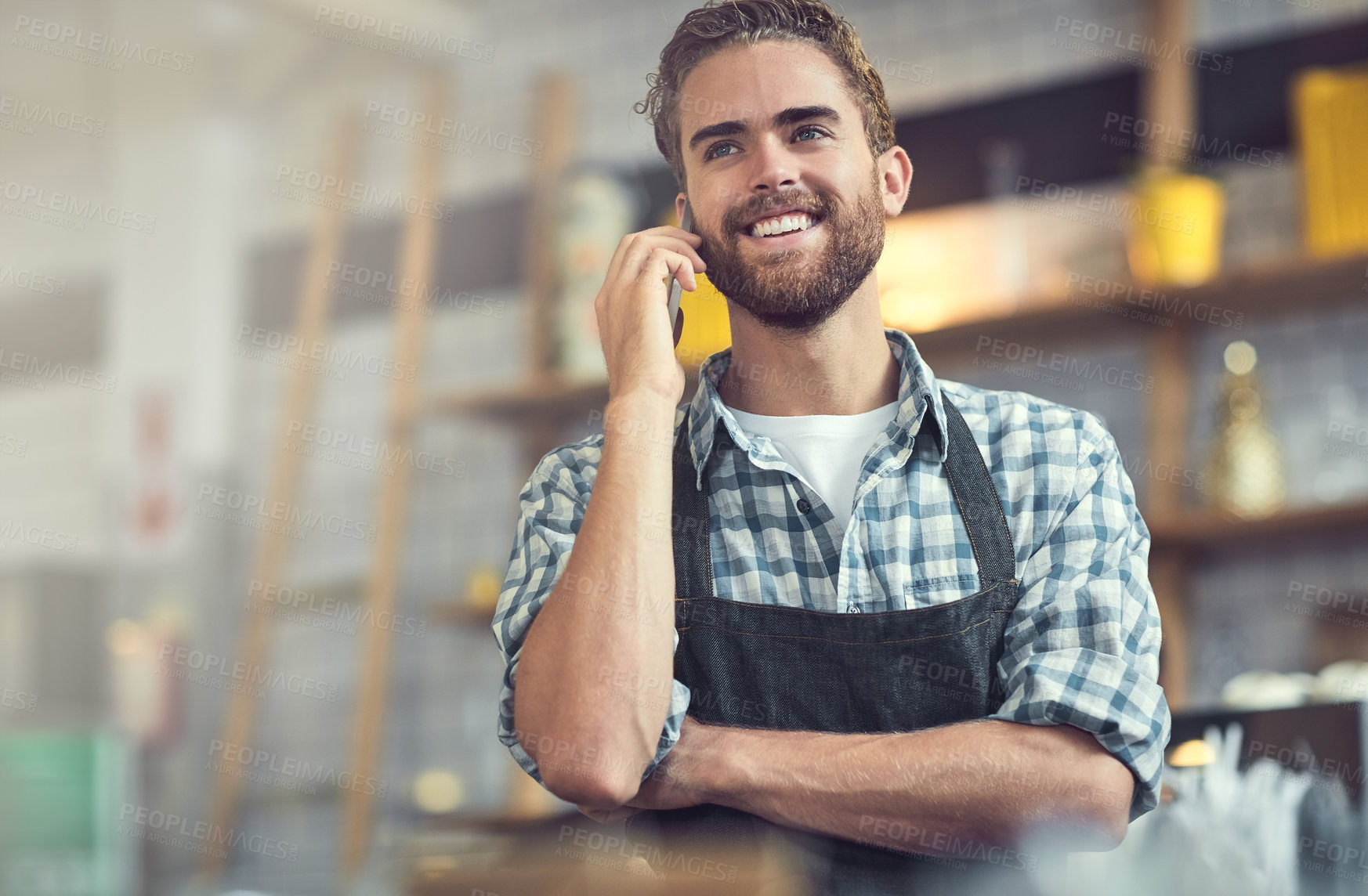 Buy stock photo Happy man, waiter or discussion with phone call at cafe for small business, reservation or conversation. Young, male person or barista with smile on mobile smartphone for booking at indoor restaurant