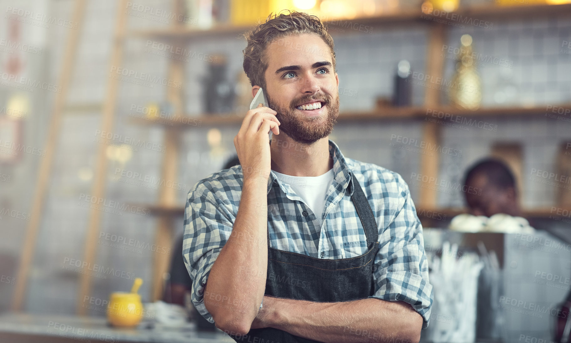 Buy stock photo Happy man, waiter or conversation with phone call at cafe for small business, reservation or discussion. Young, male person or barista with smile on mobile smartphone for booking at indoor restaurant